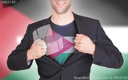 Image of Businessman opening suit to reveal shirt with flag