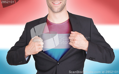 Image of Businessman opening suit to reveal shirt with flag