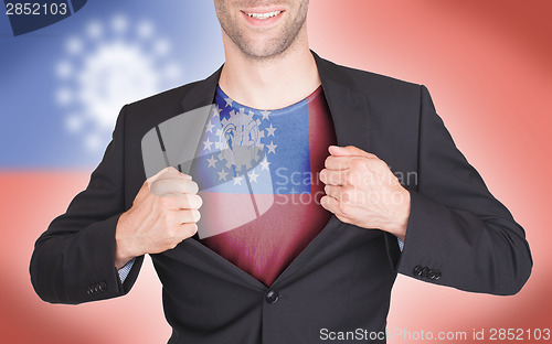 Image of Businessman opening suit to reveal shirt with flag