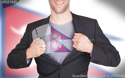 Image of Businessman opening suit to reveal shirt with flag