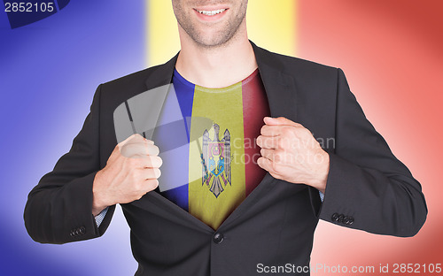 Image of Businessman opening suit to reveal shirt with flag