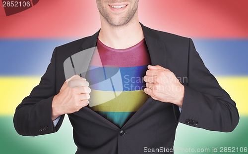 Image of Businessman opening suit to reveal shirt with flag