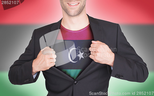 Image of Businessman opening suit to reveal shirt with flag