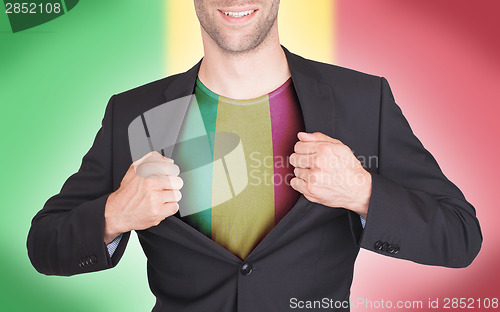 Image of Businessman opening suit to reveal shirt with flag