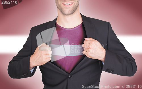 Image of Businessman opening suit to reveal shirt with flag