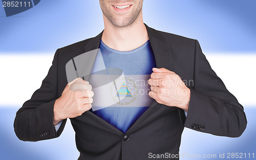 Image of Businessman opening suit to reveal shirt with flag