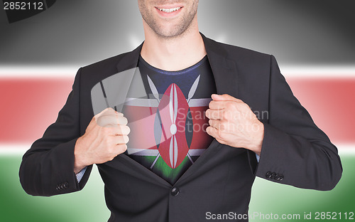 Image of Businessman opening suit to reveal shirt with flag