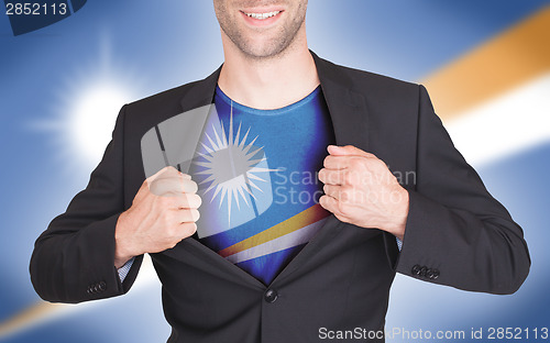 Image of Businessman opening suit to reveal shirt with flag