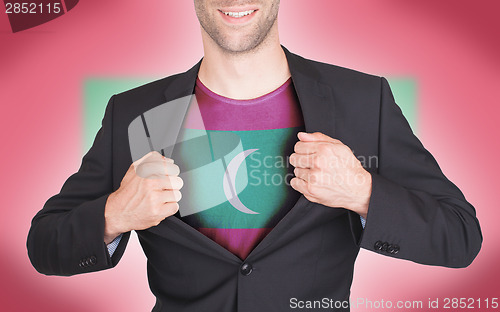 Image of Businessman opening suit to reveal shirt with flag