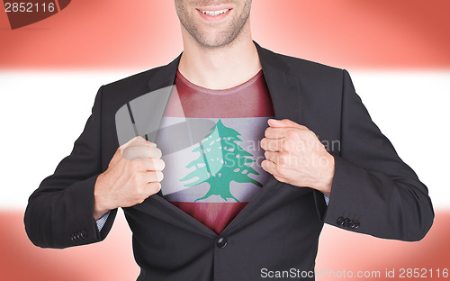 Image of Businessman opening suit to reveal shirt with flag