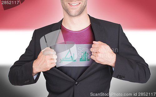 Image of Businessman opening suit to reveal shirt with flag