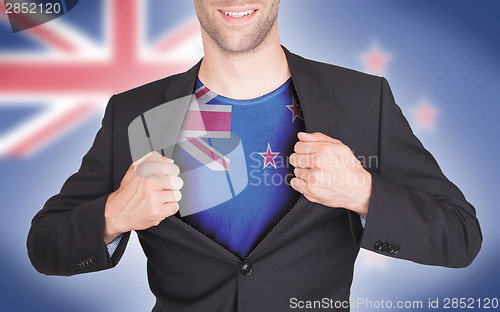 Image of Businessman opening suit to reveal shirt with flag