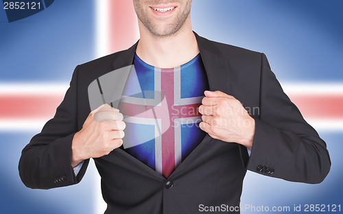 Image of Businessman opening suit to reveal shirt with flag