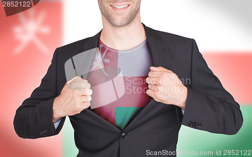 Image of Businessman opening suit to reveal shirt with flag