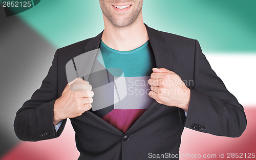 Image of Businessman opening suit to reveal shirt with flag