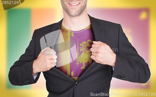 Image of Businessman opening suit to reveal shirt with flag