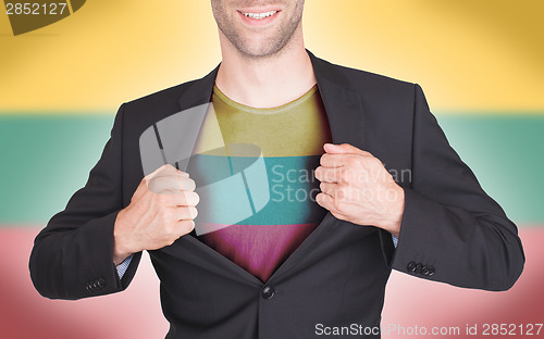 Image of Businessman opening suit to reveal shirt with flag