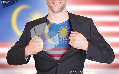 Image of Businessman opening suit to reveal shirt with flag