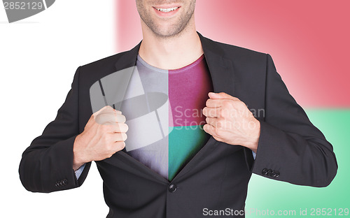 Image of Businessman opening suit to reveal shirt with flag