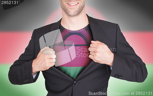 Image of Businessman opening suit to reveal shirt with flag