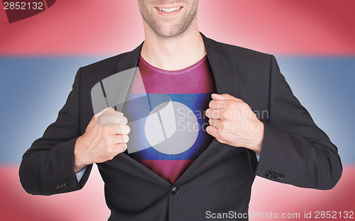 Image of Businessman opening suit to reveal shirt with flag