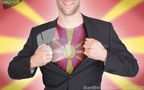 Image of Businessman opening suit to reveal shirt with flag