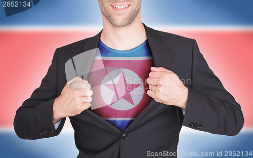 Image of Businessman opening suit to reveal shirt with flag