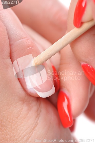 Image of manicure applying - cleaning the cuticles 