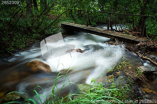 Image of walking bridge over flowing stream