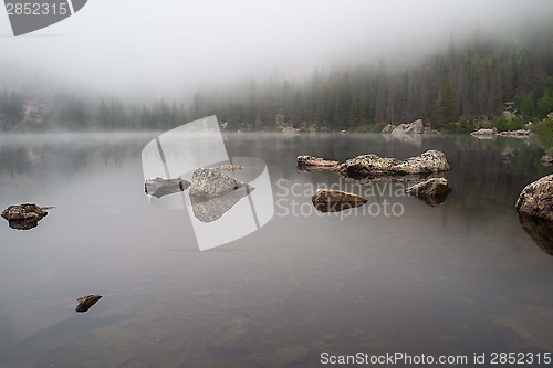 Image of Rocks reflected in a foggy lake
