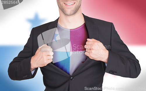 Image of Businessman opening suit to reveal shirt with flag