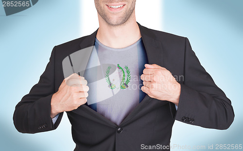 Image of Businessman opening suit to reveal shirt with flag