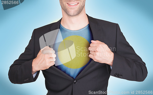 Image of Businessman opening suit to reveal shirt with flag