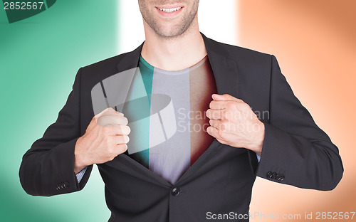 Image of Businessman opening suit to reveal shirt with flag