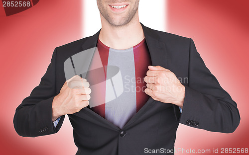 Image of Businessman opening suit to reveal shirt with flag