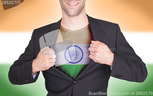 Image of Businessman opening suit to reveal shirt with flag