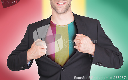 Image of Businessman opening suit to reveal shirt with flag