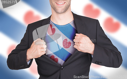 Image of Businessman opening suit to reveal shirt with flag