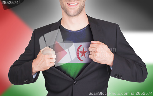 Image of Businessman opening suit to reveal shirt with flag