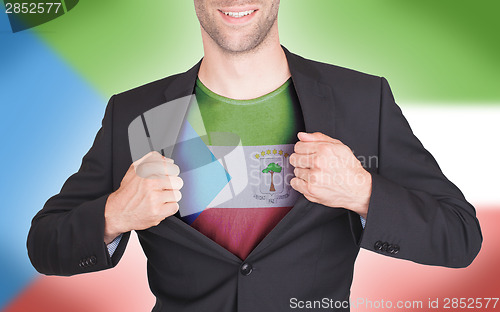 Image of Businessman opening suit to reveal shirt with flag