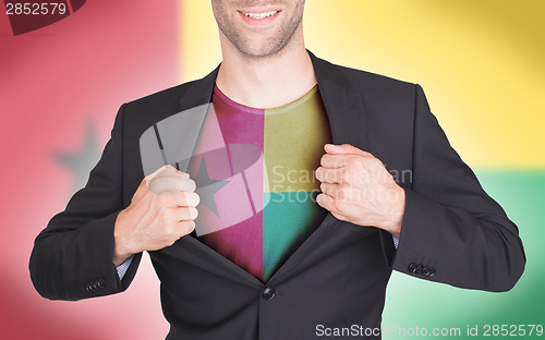 Image of Businessman opening suit to reveal shirt with flag