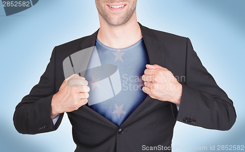 Image of Businessman opening suit to reveal shirt with flag