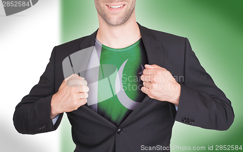 Image of Businessman opening suit to reveal shirt with flag