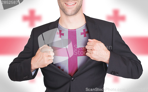 Image of Businessman opening suit to reveal shirt with flag