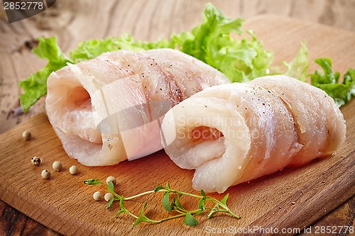 Image of raw hake fish fillet rolls