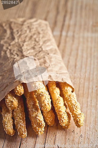 Image of bread sticks grissini with sesame seeds in craft pack