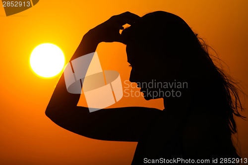 Image of Woman at sunset