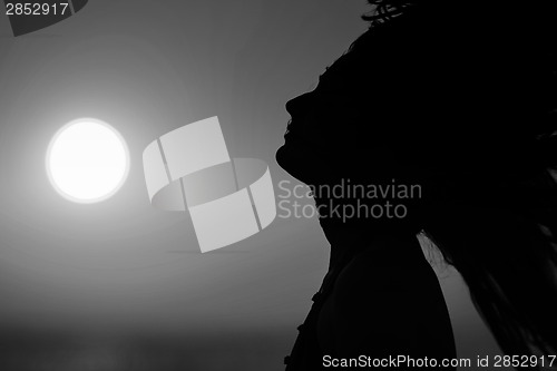 Image of Young woman at sunset black and white