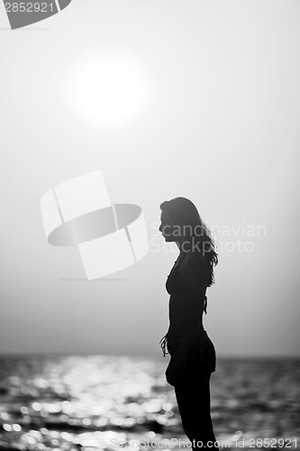 Image of Woman silhouette at sunset black and white