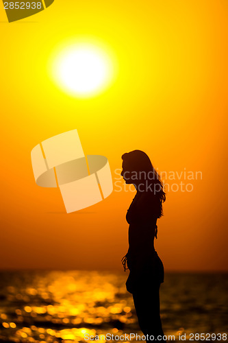 Image of Woman silhouette at sunset